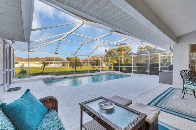 outdoor pool with glass enclosure and a patio