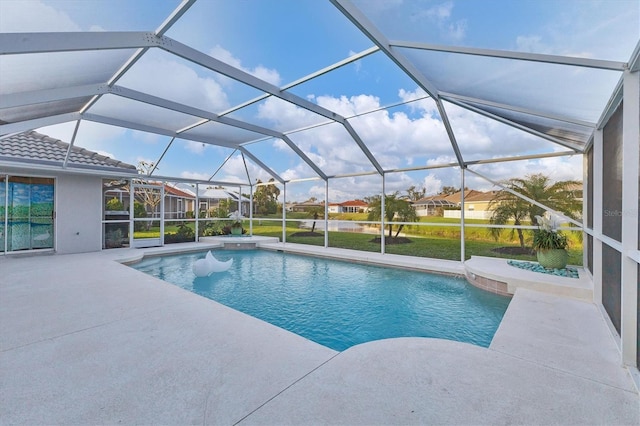 pool featuring glass enclosure and a patio