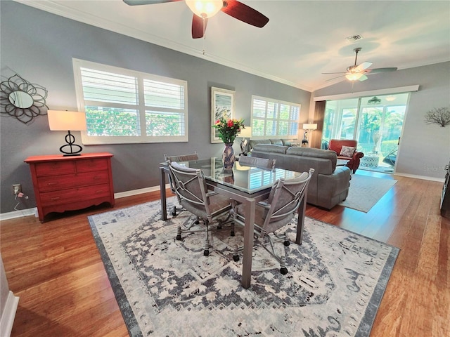 dining room with baseboards, wood finished floors, ceiling fan, and ornamental molding