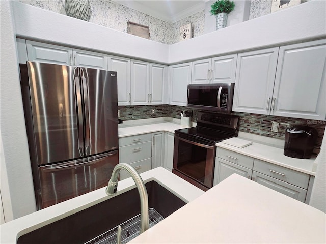 kitchen with gray cabinetry, a sink, light countertops, appliances with stainless steel finishes, and tasteful backsplash