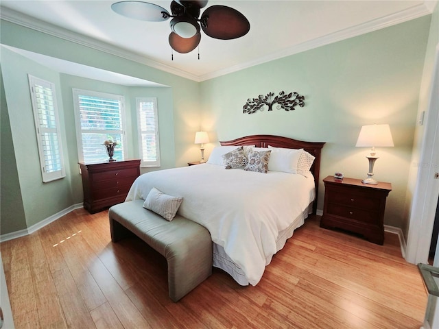 bedroom featuring a ceiling fan, crown molding, baseboards, and light wood-type flooring