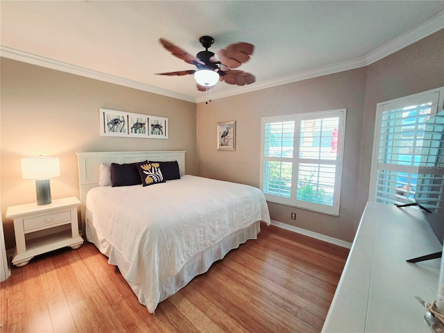 bedroom with light wood-style flooring, a ceiling fan, baseboards, and ornamental molding