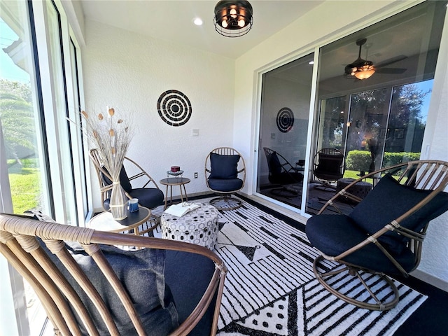 sunroom featuring ceiling fan