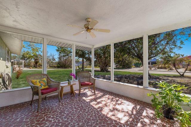 sunroom / solarium with a healthy amount of sunlight and ceiling fan