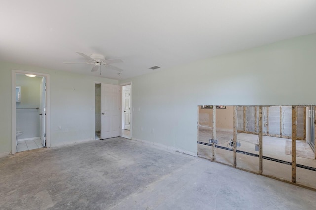 empty room with visible vents, unfinished concrete flooring, and ceiling fan