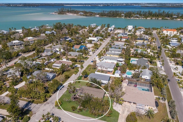 drone / aerial view with a residential view and a water view