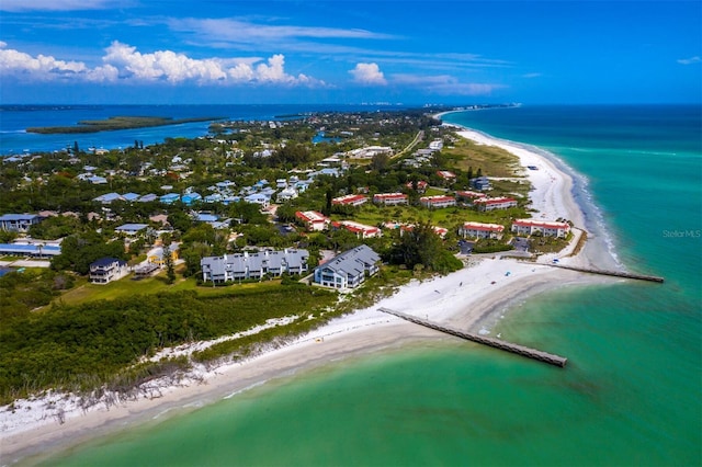 birds eye view of property with a water view and a view of the beach