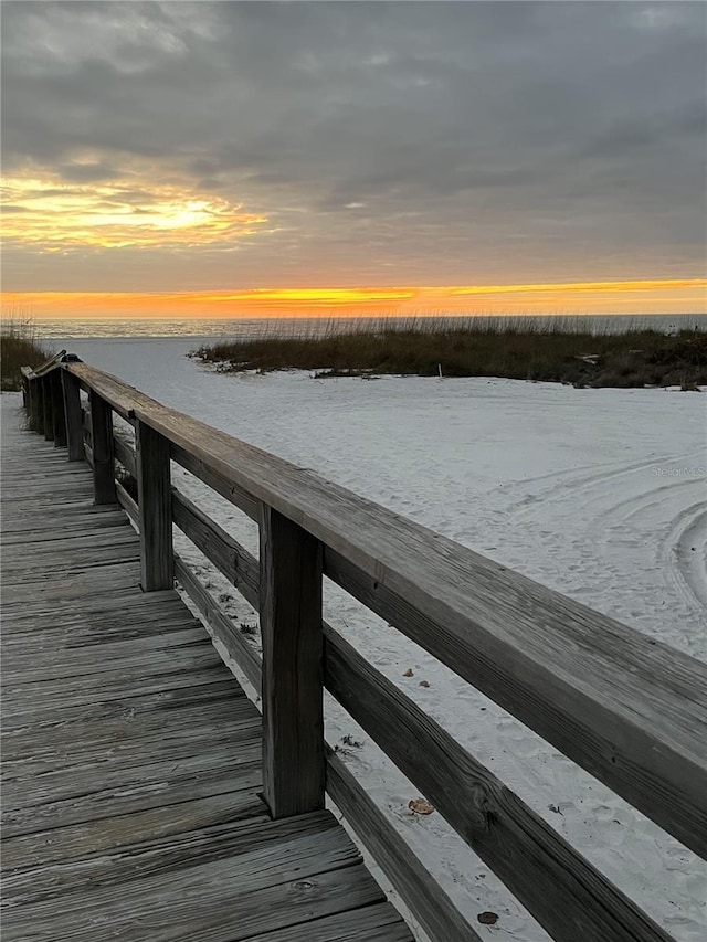 dock area featuring a water view and a view of the beach