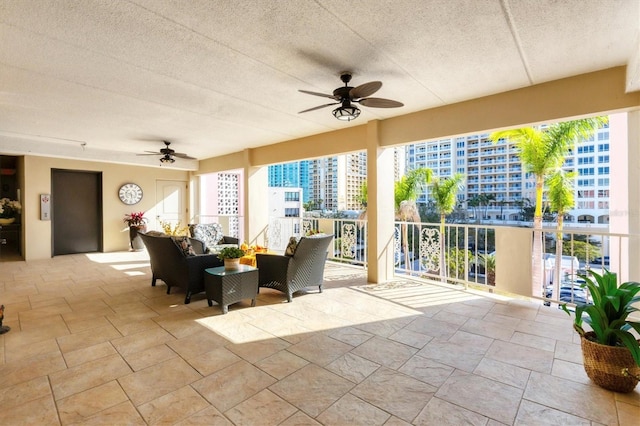 view of patio with a city view, an outdoor living space, elevator, and ceiling fan