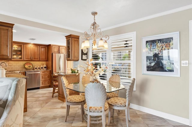 dining area with a notable chandelier, visible vents, baseboards, and ornamental molding