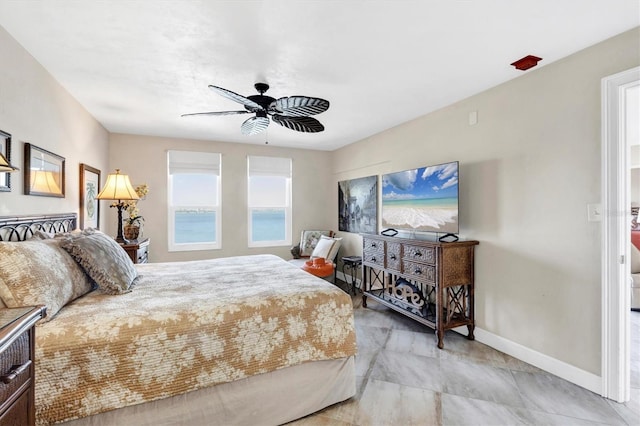 bedroom featuring a ceiling fan and baseboards