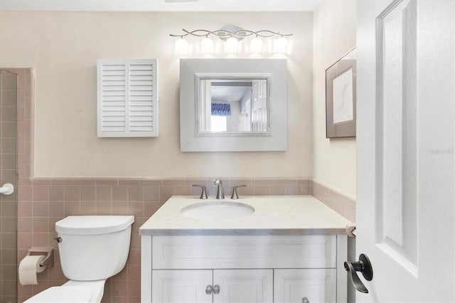 full bath featuring toilet, tile walls, and vanity