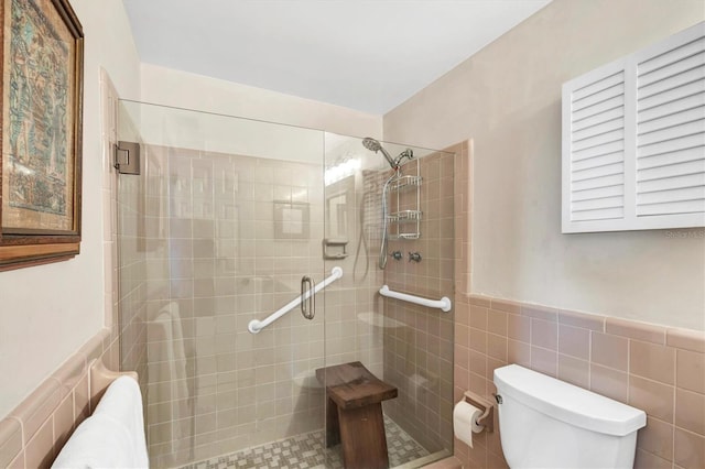 full bath featuring toilet, tile walls, and a shower stall