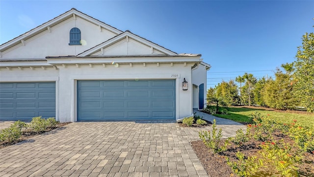 garage with decorative driveway