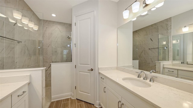 full bathroom featuring visible vents, vanity, walk in shower, and wood tiled floor