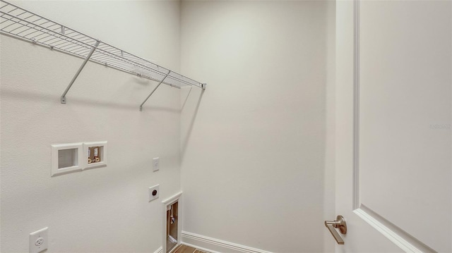 washroom featuring laundry area, hookup for a washing machine, hookup for an electric dryer, and baseboards