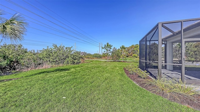 view of yard with glass enclosure