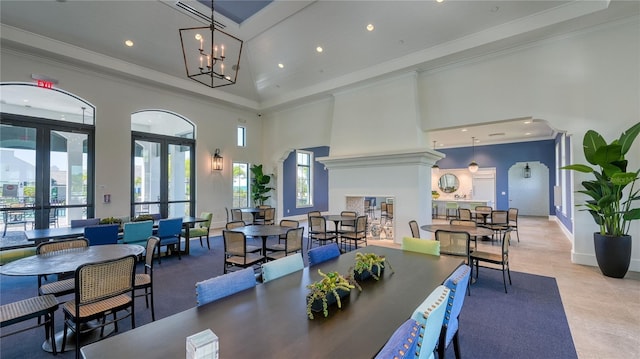 dining space with recessed lighting, french doors, crown molding, baseboards, and a towering ceiling