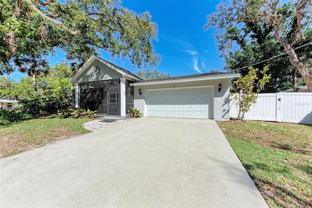 view of front of house featuring stucco siding, a gate, fence, concrete driveway, and an attached garage