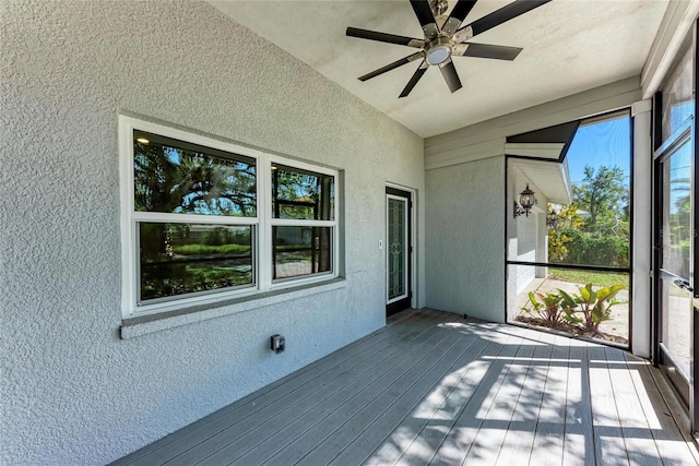 unfurnished sunroom featuring lofted ceiling and ceiling fan