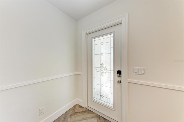 foyer entrance with baseboards and a healthy amount of sunlight