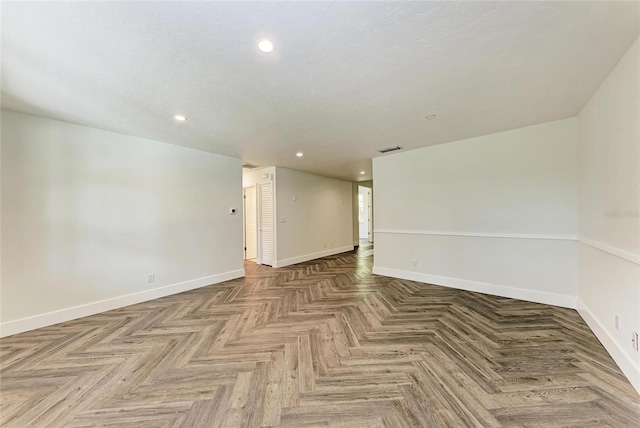 spare room featuring visible vents, recessed lighting, a textured ceiling, and baseboards