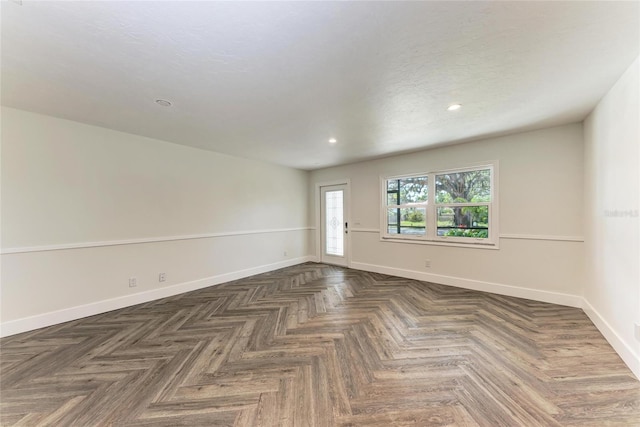 empty room with recessed lighting, baseboards, and a textured ceiling