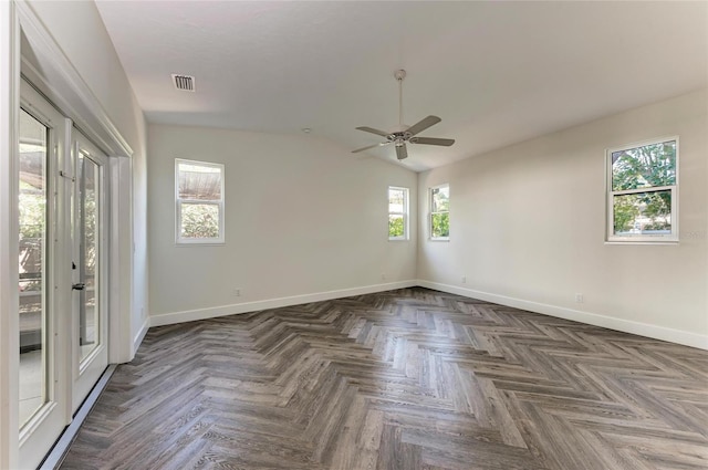 empty room featuring visible vents, baseboards, a ceiling fan, and vaulted ceiling