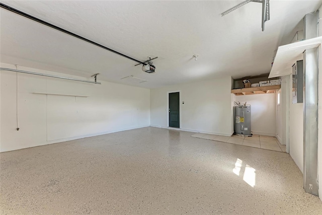 garage featuring water heater and a garage door opener