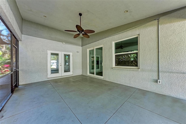 unfurnished sunroom with french doors and ceiling fan