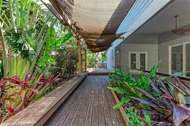 wooden terrace featuring french doors and a ceiling fan