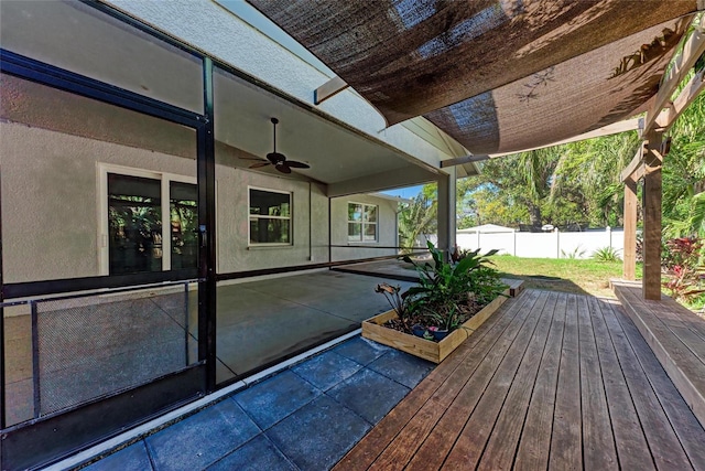 wooden deck featuring a ceiling fan, a patio, and fence