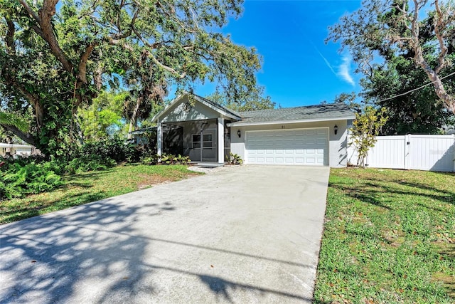 ranch-style house with fence, concrete driveway, a front yard, stucco siding, and an attached garage