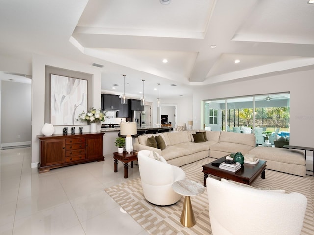 living room with light tile patterned floors, visible vents, a raised ceiling, and recessed lighting