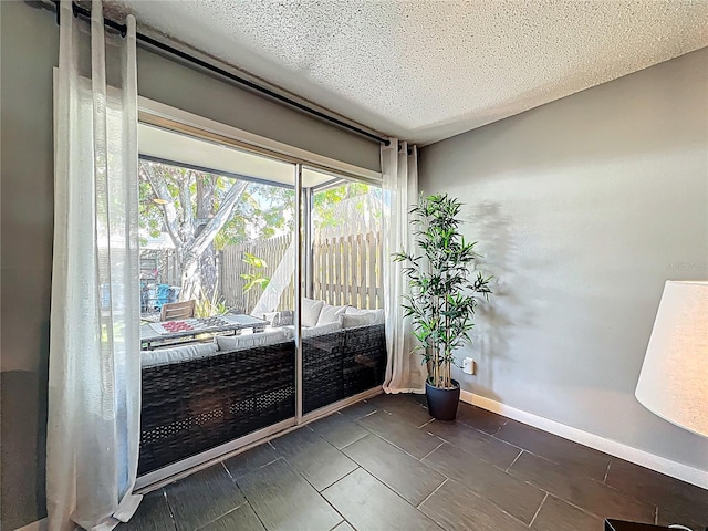 interior space featuring baseboards and a textured ceiling