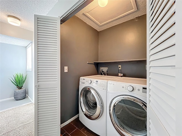 laundry area with baseboards, a textured ceiling, laundry area, and washer and clothes dryer