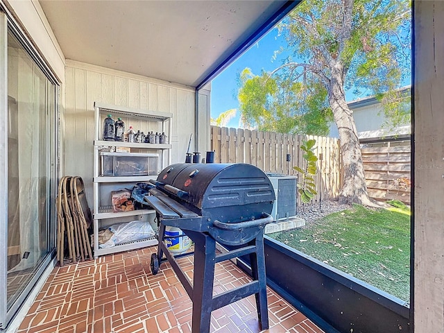 exterior space with cooling unit, area for grilling, and fence