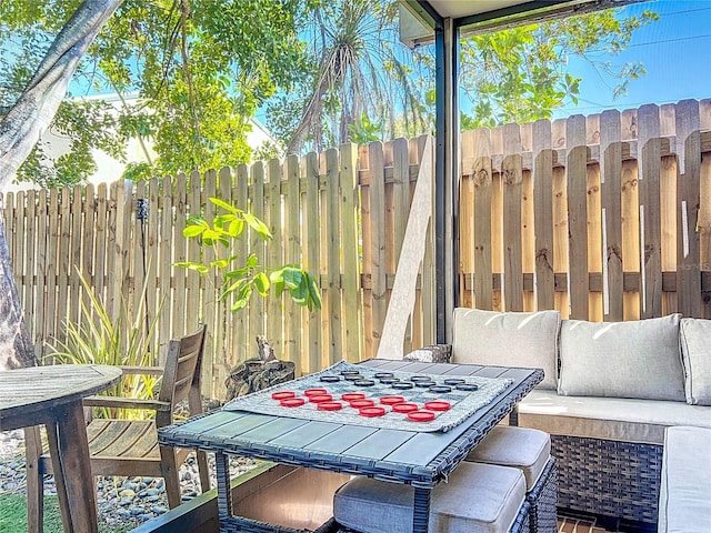 exterior space featuring outdoor dining space and fence