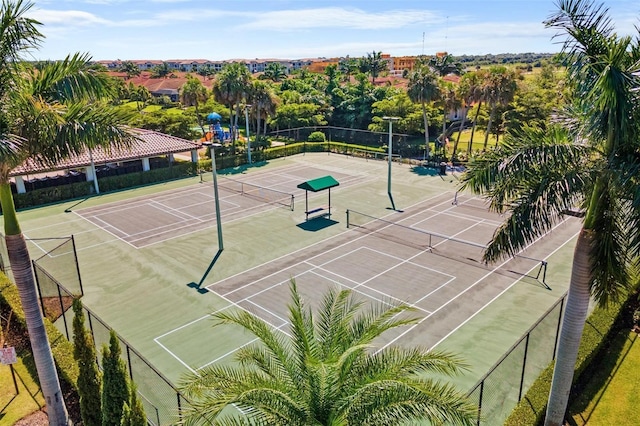 view of tennis court featuring fence