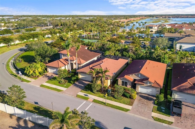 birds eye view of property with a residential view and a water view