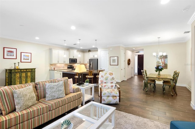 living area with visible vents, a notable chandelier, dark wood-type flooring, arched walkways, and crown molding