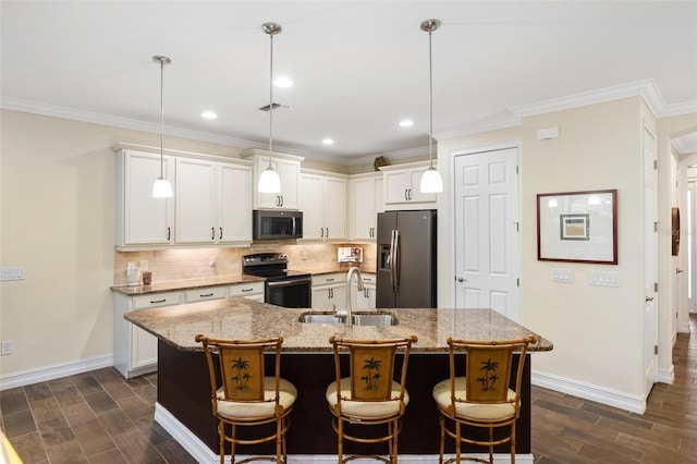 kitchen with decorative backsplash, stainless steel appliances, wood finish floors, and a sink