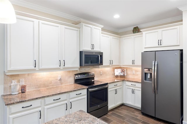 kitchen featuring ornamental molding, backsplash, appliances with stainless steel finishes, white cabinets, and light stone countertops