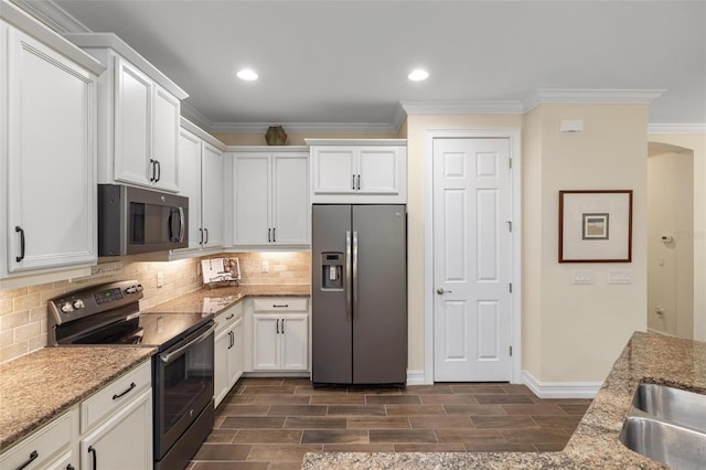 kitchen featuring decorative backsplash, range with electric stovetop, white cabinetry, and stainless steel fridge with ice dispenser