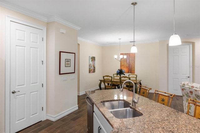 kitchen with baseboards, dark wood finished floors, an inviting chandelier, ornamental molding, and a sink