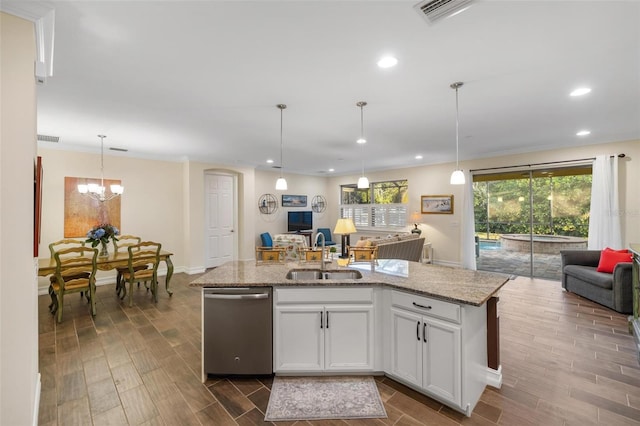 kitchen featuring visible vents, wood tiled floor, a sink, stainless steel dishwasher, and open floor plan