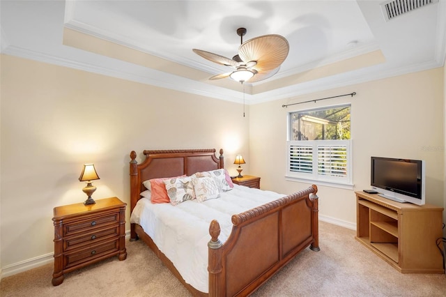 bedroom with light carpet, visible vents, and a raised ceiling