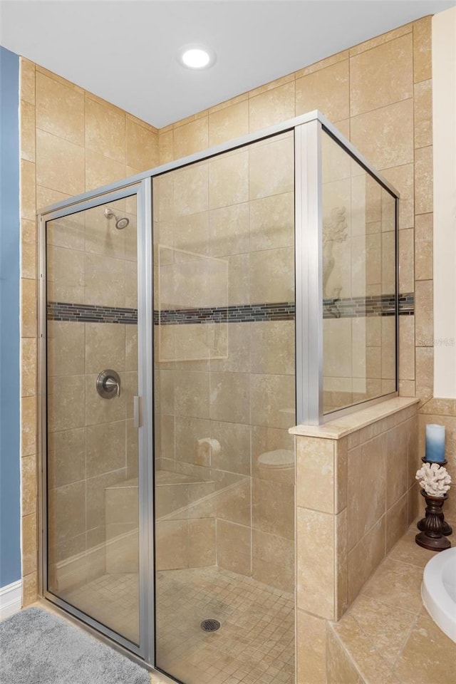 bathroom with a shower stall and a bath