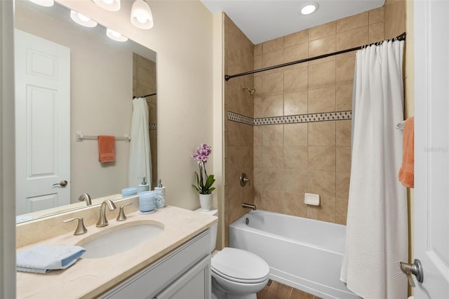 bathroom featuring vanity, toilet, and shower / bath combo with shower curtain