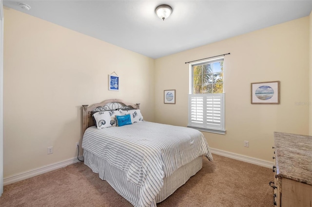 carpeted bedroom featuring baseboards